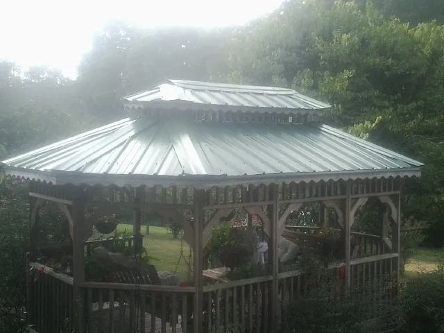 Two tier green metal roof on a garden gazebo in Goodell