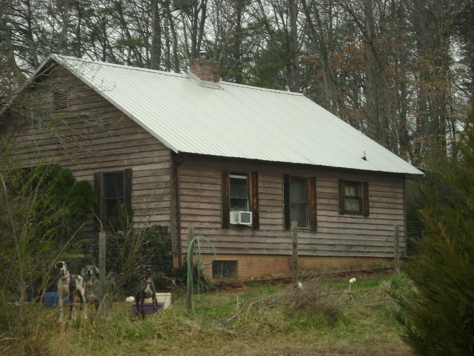 White metal roof on an old wood sided farmhouse, from a Metal Roof Installation job in Goodell